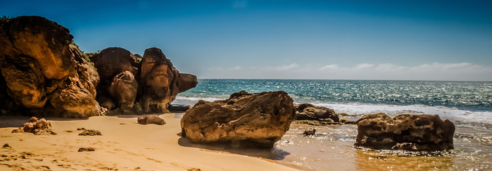 Sandy coastline with large rocks